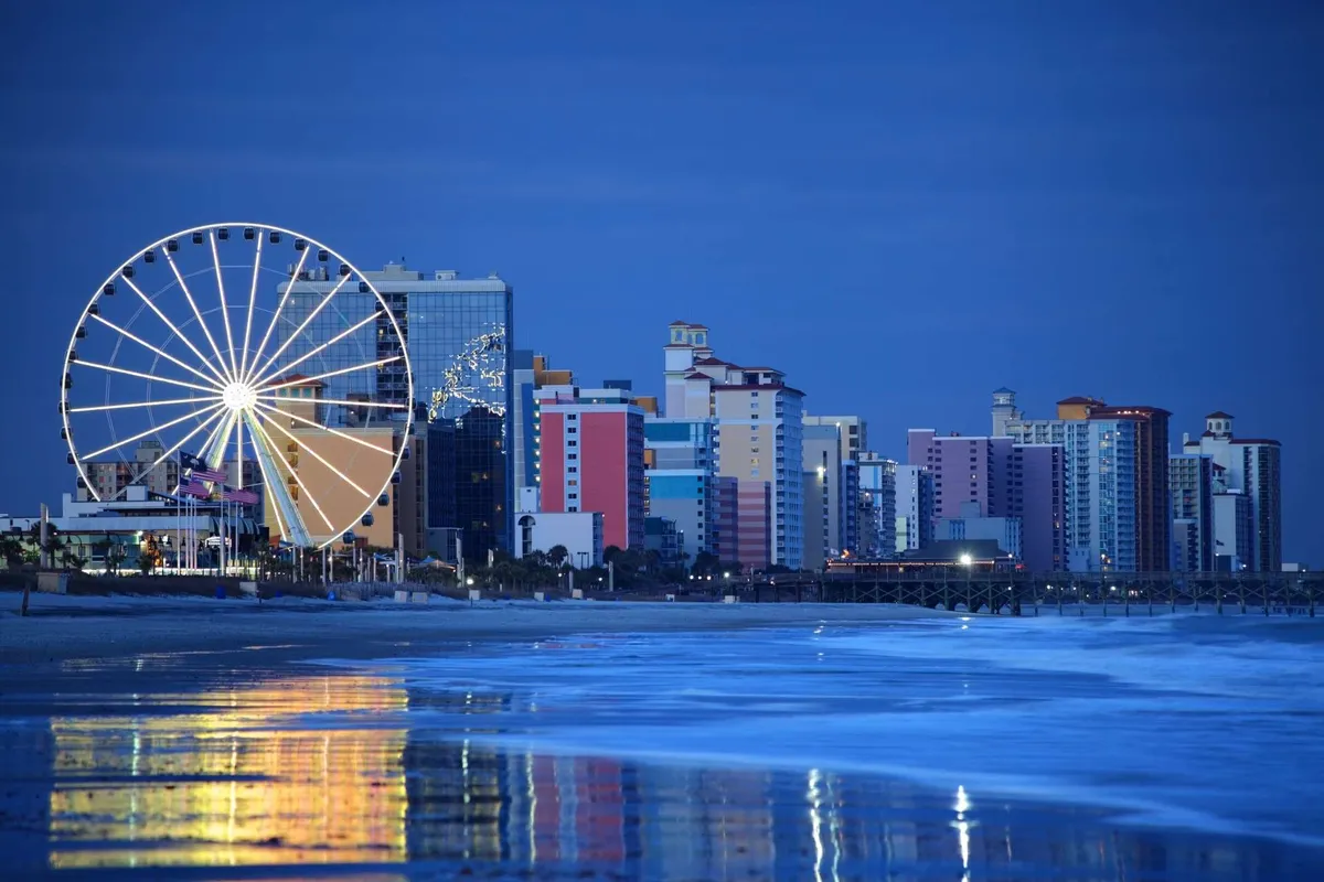 A colorful and playful scene featuring the iconic ferris wheel, vibrant beachside buildings, and rolling ocean waves. The atmosphere is lively and festive, evoking the joy of amusement park rides and beach strolls in a classic coastal setting.